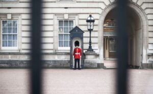 Member of the King's Guard standing in front of Buckingham Palace.